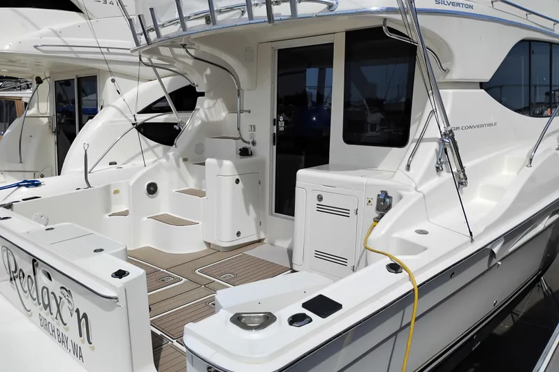 Slide: The Image of 2005 Silverton 38 Convertible yacht with spacious deck and modern amenities. - 3