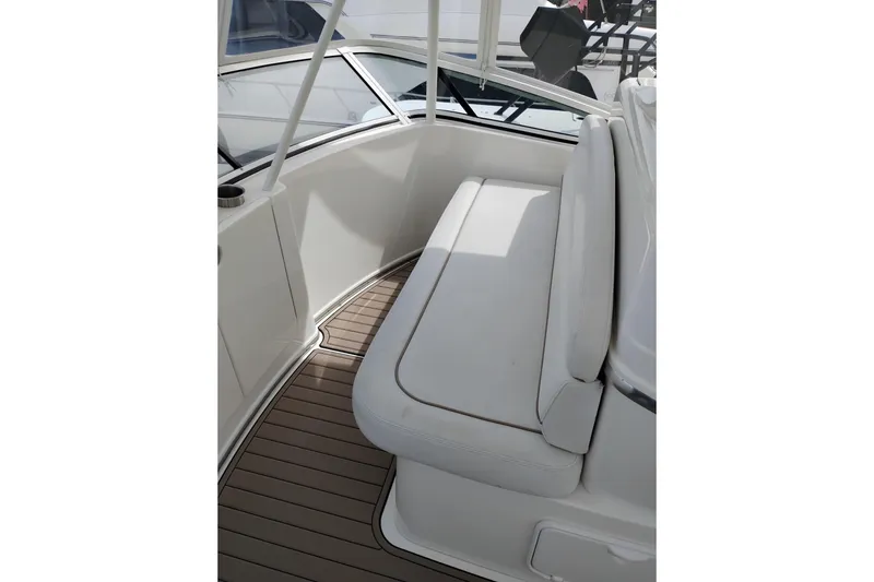 Slide: The Image of 2005 Silverton 38 Convertible boat interior with cushioned seating and wooden flooring. - 32
