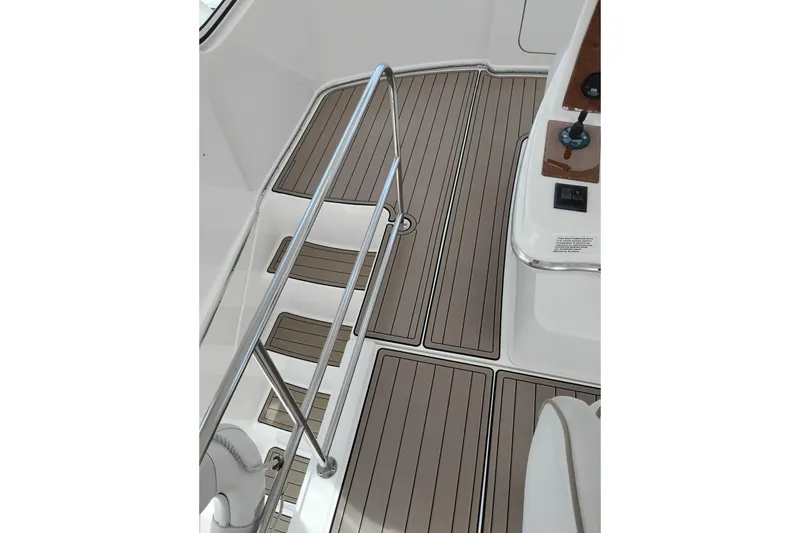 Slide: The Image of 2005 Silverton 38 Convertible boat deck with sleek wood finish and metal railing. - 33