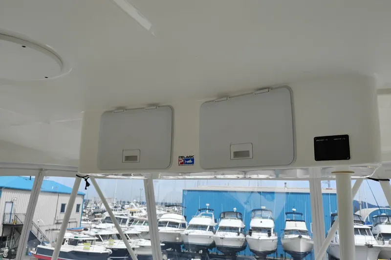 Slide: The Image of 2005 Silverton 38 Convertible boat interior with storage compartments, marina view in background. - 36