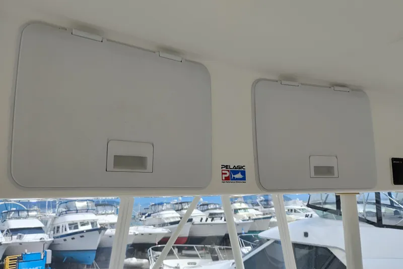 Slide: The Image of 2005 Silverton 38 Convertible boat interior with storage compartments and marina view. - 37