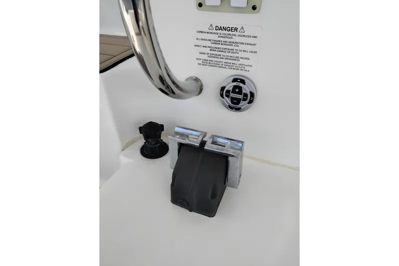 Slide: The Image of 2005 Silverton 38 Convertible boat control panel with warning label and controls. - 40