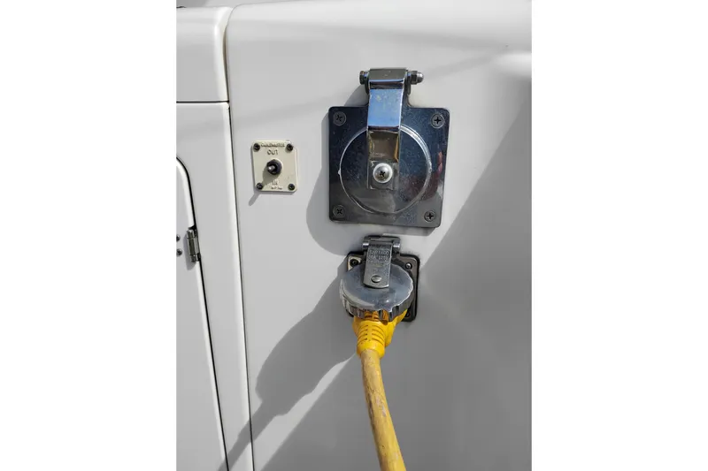 Slide: The Image of 2005 Silverton 38 Convertible boat power outlet with yellow cable connected. - 42