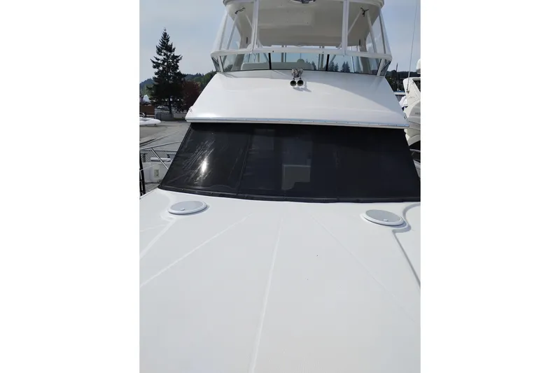 Slide: The Image of 2005 Silverton 38 Convertible yacht with sleek white exterior and spacious deck. - 43