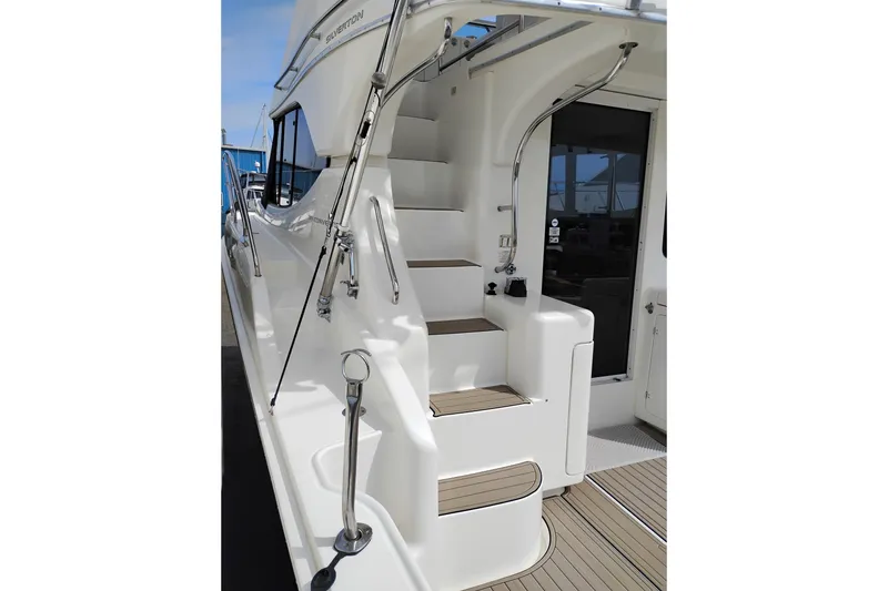 Slide: The Image of 2005 Silverton 38 Convertible yacht with sleek exterior stairs and polished railings. - 47
