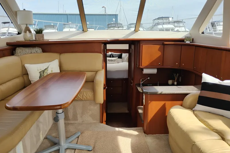 Slide: The Image of Interior of 2005 Silverton 38 Convertible yacht with cozy seating and kitchenette. - 48