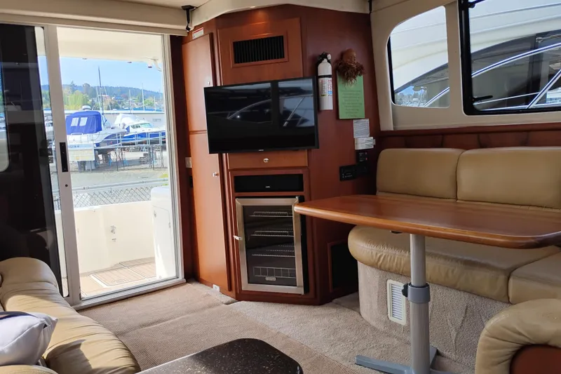 Slide: The Image of Interior of 2005 Silverton 38 Convertible yacht with seating, table, and TV. - 50