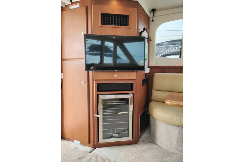 Slide: The Image of Interior of 2005 Silverton 38 Convertible yacht with TV and mini fridge. - 51