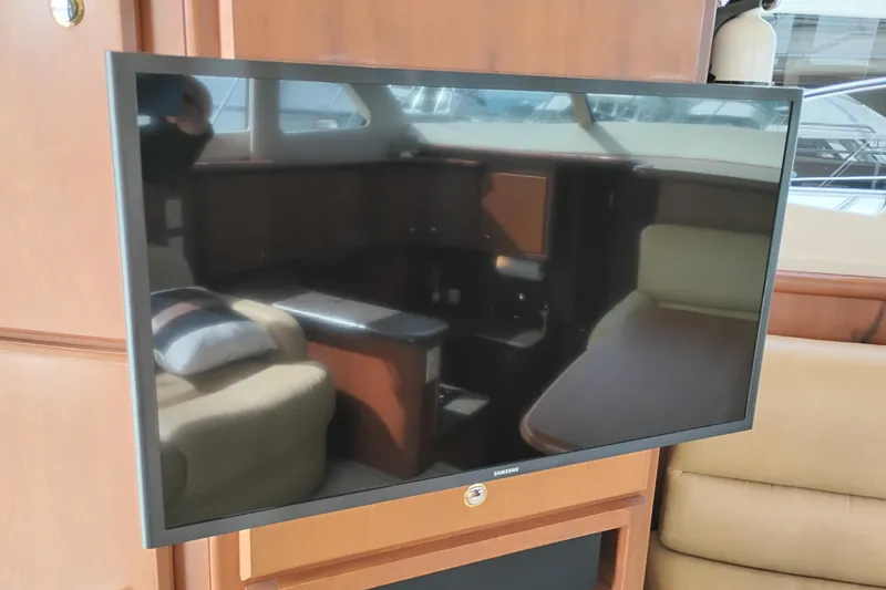 Slide: The Image of Flat-screen TV inside 2005 Silverton 38 Convertible yacht, reflecting luxurious interior. - 52