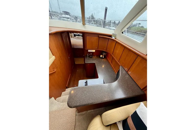 Slide: The Image of 2005 Silverton 38 Convertible yacht interior with wood cabinetry and modern kitchen design. - 59