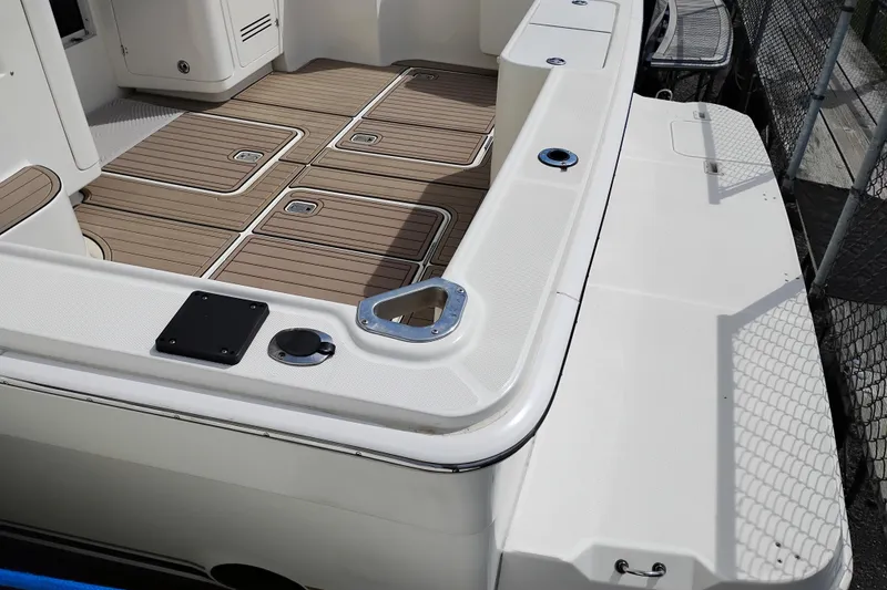 Slide: The Image of 2005 Silverton 38 Convertible boat deck with wood finish and storage compartments. - 6