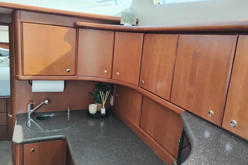Slide: The Image of 2005 Silverton 38 Convertible yacht interior with wooden cabinets and sleek countertop. - 61