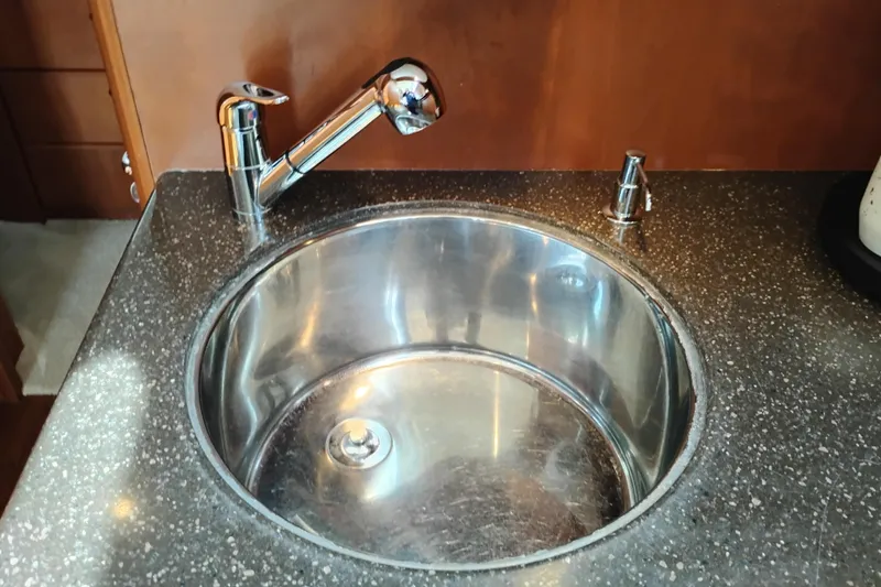 Slide: The Image of Stainless steel sink with chrome faucet in 2005 Silverton 38 Convertible yacht kitchen. - 63