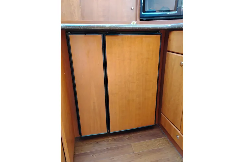 Slide: The Image of Wooden cabinetry in 2005 Silverton 38 Convertible yacht interior kitchen area. - 66