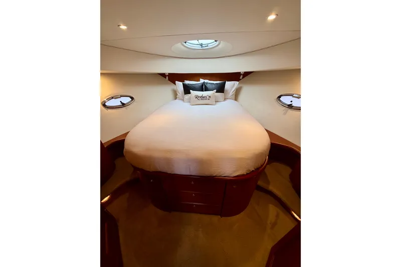 Slide: The Image of Luxurious bedroom interior of 2005 Silverton 38 Convertible yacht with plush bedding. - 69