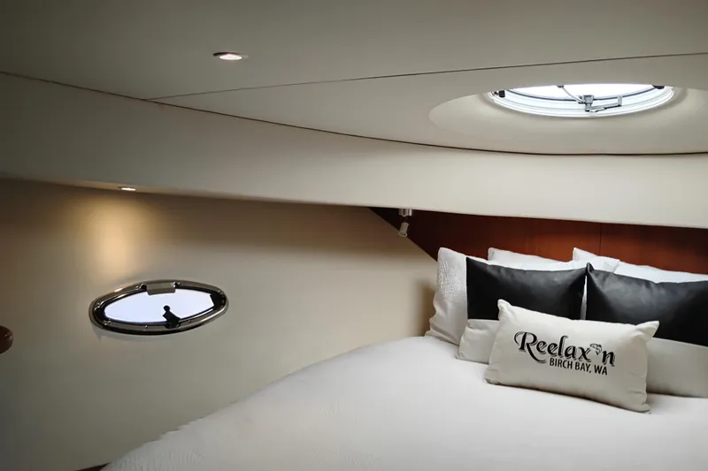 Slide: The Image of Interior cabin of 2005 Silverton 38 Convertible yacht with cozy bedding and porthole window. - 70