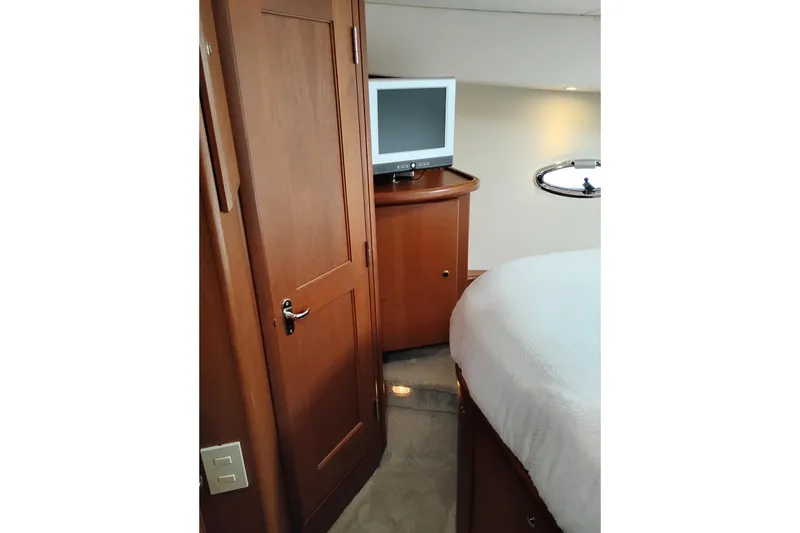 Slide: The Image of Interior of 2005 Silverton 38 Convertible yacht with TV and wooden cabinetry. - 71