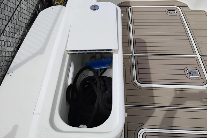 Slide: The Image of Storage compartment on 2005 Silverton 38 Convertible boat deck with rope and brush. - 8
