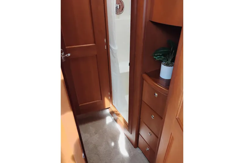 Slide: The Image of Interior of 2005 Silverton 38 Convertible yacht with wooden cabinetry and potted plant. - 82