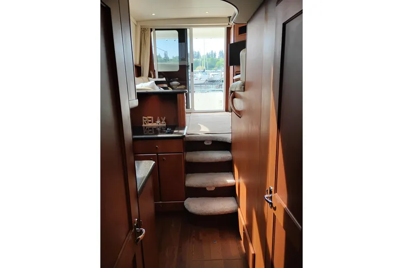 Slide: The Image of Interior of 2005 Silverton 38 Convertible yacht with wooden cabinetry and carpeted stairs. - 83