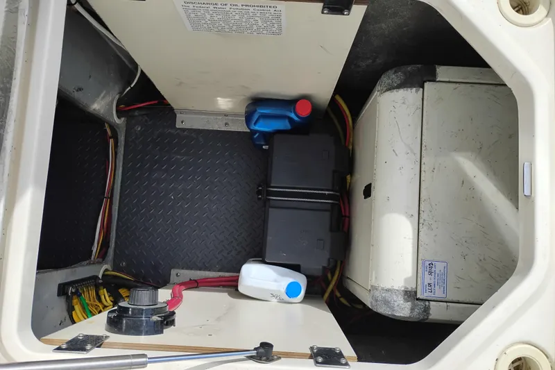 Slide: The Image of Engine compartment of a 2005 Silverton 38 Convertible boat with batteries and oil containers. - 84
