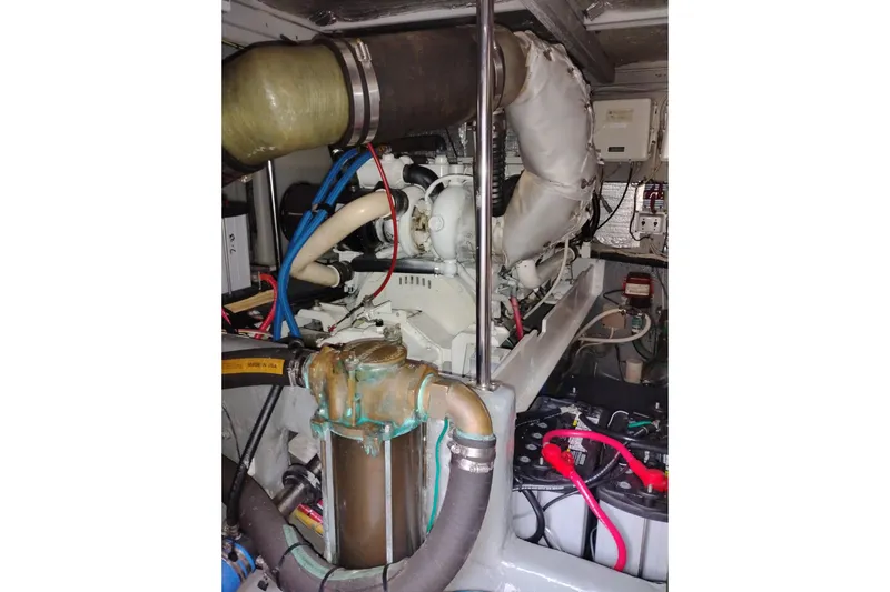 Slide: The Image of Engine room of a 2005 Silverton 38 Convertible yacht, showcasing mechanical components. - 85