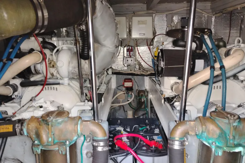 Slide: The Image of Engine room of a 2005 Silverton 38 Convertible yacht, showcasing dual engines and wiring. - 86