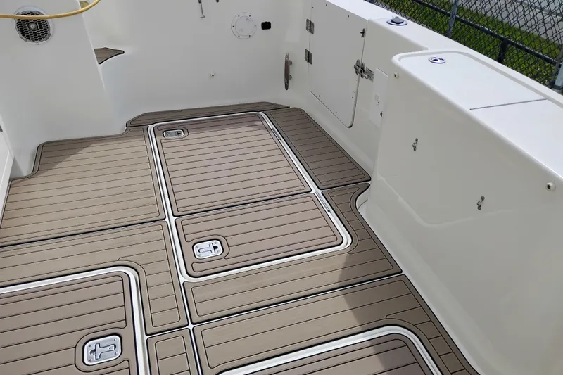 Slide: The Image of 2005 Silverton 38 Convertible boat deck with teak-style flooring and storage compartments. - 9