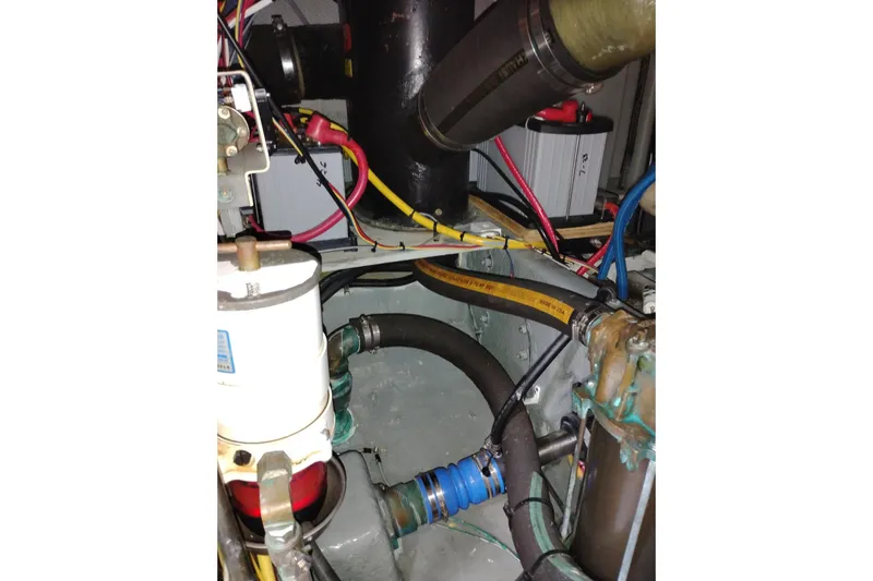 Slide: The Image of Engine compartment of a 2005 Silverton 38 Convertible boat, showcasing hoses and wiring. - 90