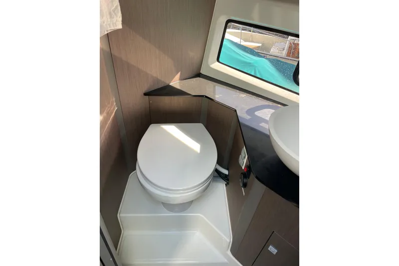 Slide: The Image of 2023 Beneteau Gran Turismo 32 yacht with black cover, docked outdoors. - 8