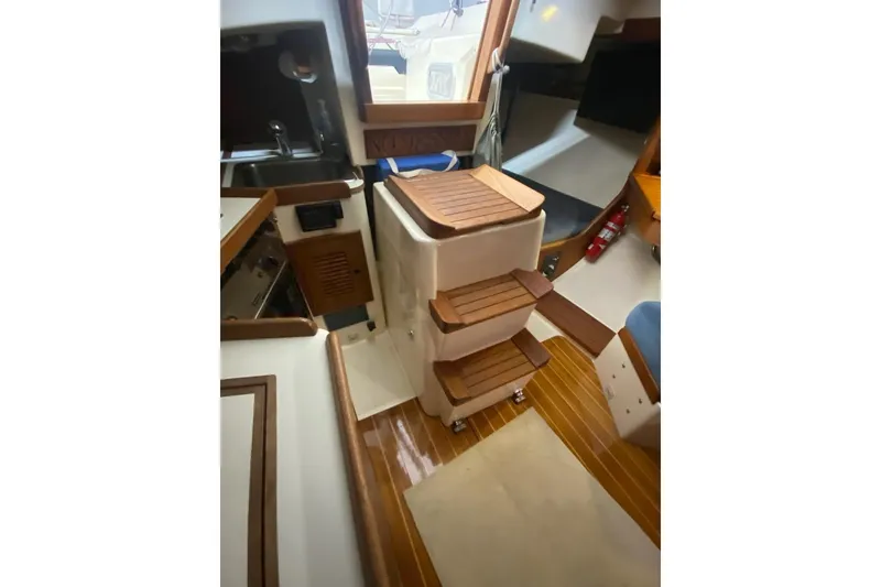 Slide: The Image of Interior of 1992 Tartan 31 Piper sailboat with wooden steps and compact layout. - 10
