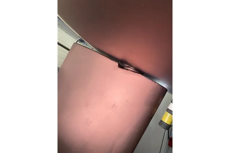 Slide: The Image of Close-up of a 1992 Tartan 31 Piper sailboat keel with visible damage. - 12