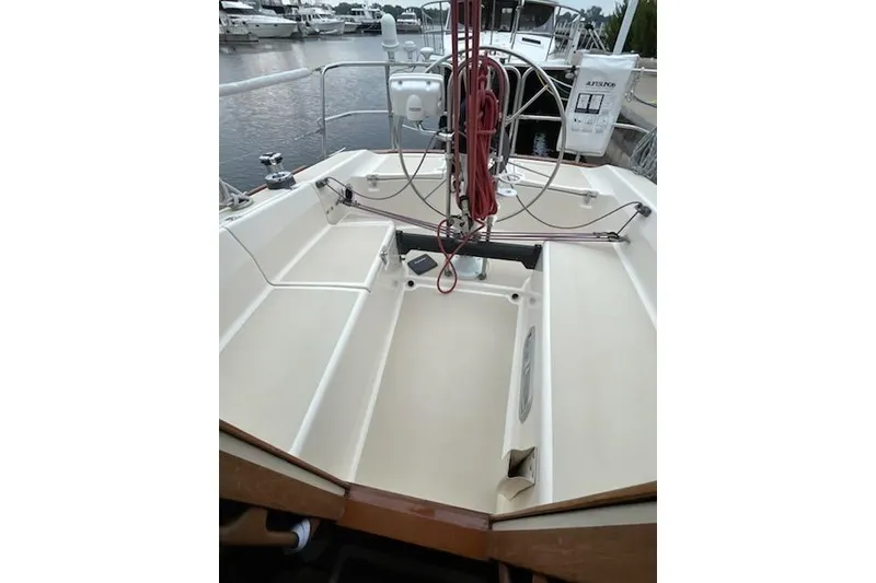 Slide: The Image of 1992 Tartan 31 Piper sailboat cockpit with steering wheel and rigging, docked at marina. - 3