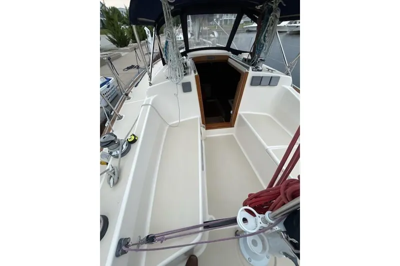 Slide: The Image of 1992 Tartan 31 Piper sailboat cockpit with ropes and winches, docked at marina. - 4
