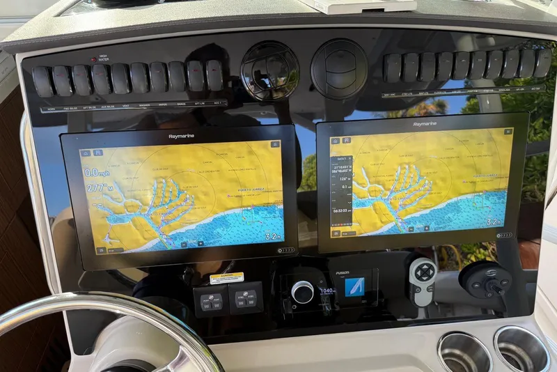 Slide: The Image of Dashboard of a 2021 Boston Whaler 380 Outrage with dual Raymarine navigation screens. - 11