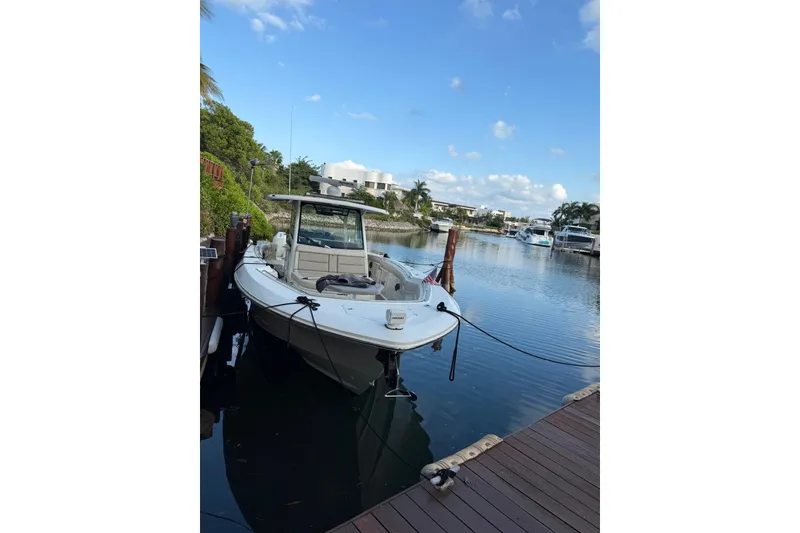 Slide: The Image of 2021 Boston Whaler 380 Outrage docked in a serene marina setting. - 13