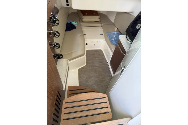 Slide: The Image of Interior cabin of 2021 Boston Whaler 380 Outrage, featuring seating and wooden accents. - 15