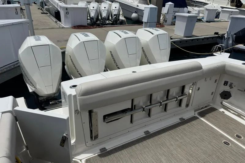 Slide: The Image of 2021 Boston Whaler 380 Outrage with four Mercury outboard engines at dock. - 6