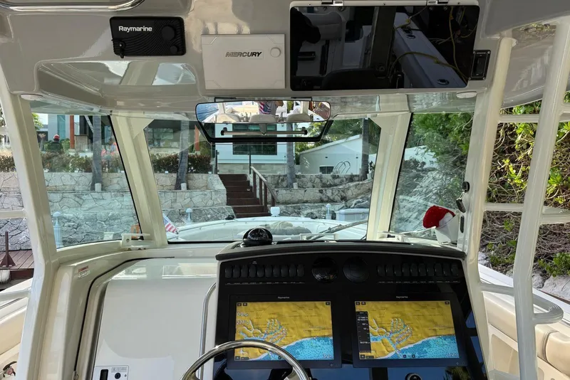 Slide: The Image of Interior view of 2021 Boston Whaler 380 Outrage boat cockpit with navigation screens. - 7
