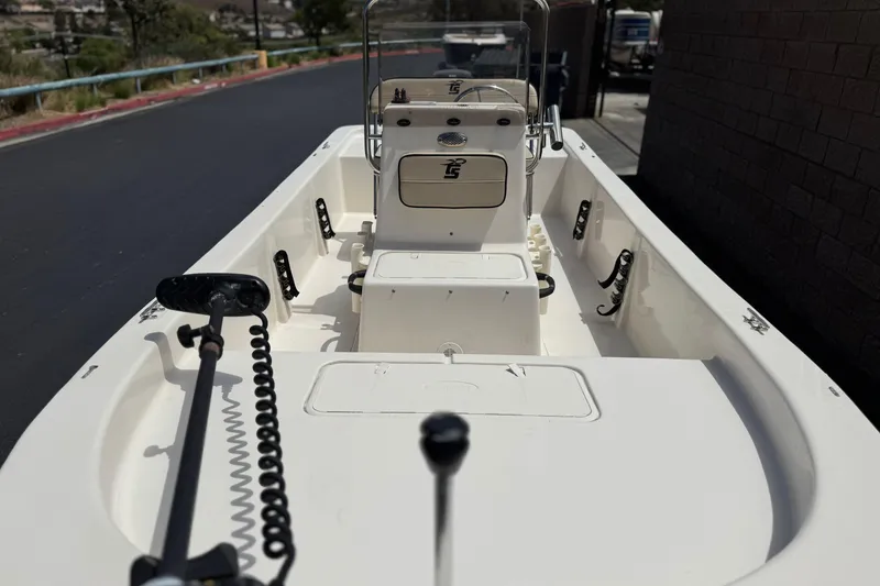 Slide: The Image of 2024 Carolina Skiff E18 JVX CC boat interior with steering console and rod holders. - 10