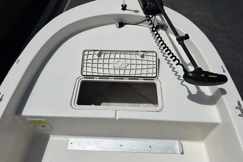 Slide: The Image of 2024 Carolina Skiff E18 JVX CC boat deck with open hatch and trolling motor. - 12