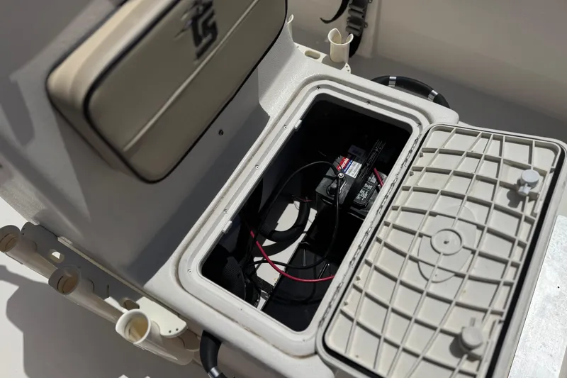 Slide: The Image of 2024 Carolina Skiff E18 JVX CC boat battery compartment with open hatch. - 14