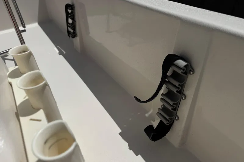 Slide: The Image of 2024 Carolina Skiff E18 JVX CC boat interior with rod holders and cup holders. - 16