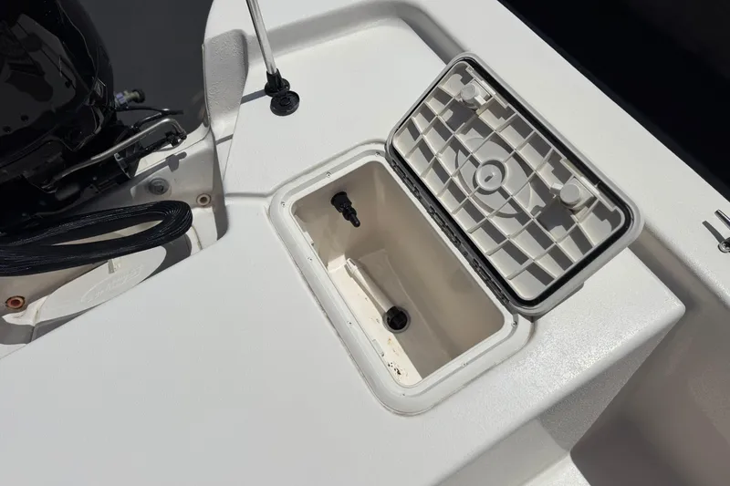 Slide: The Image of Open storage compartment on 2024 Carolina Skiff E18 JVX CC boat deck. - 18