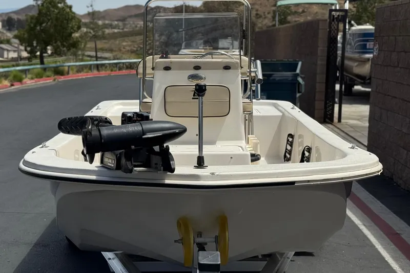 Slide: The Image of 2024 Carolina Skiff E18 JVX CC boat on trailer, parked outdoors. - 2