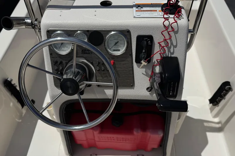 Slide: The Image of 2024 Carolina Skiff E18 JVX CC boat console with steering wheel and gauges. - 22