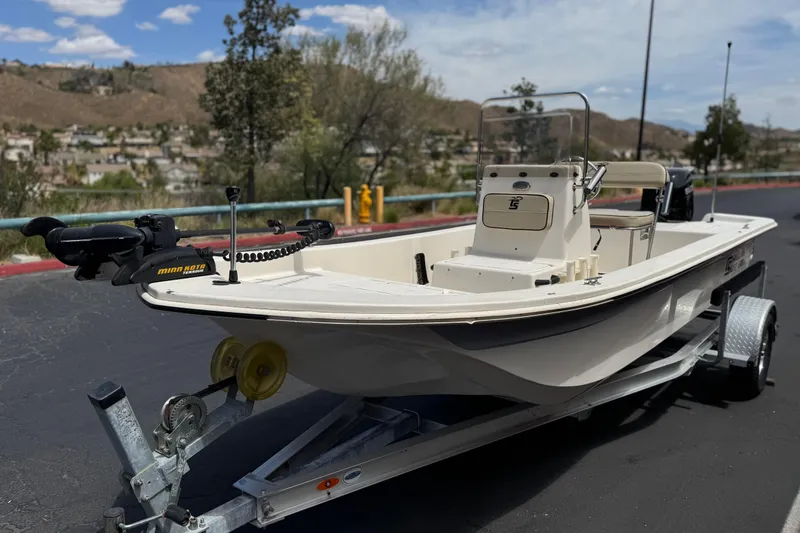 Slide: The Image of 2024 Carolina Skiff E18 JVX CC boat on trailer, parked outdoors. - 3