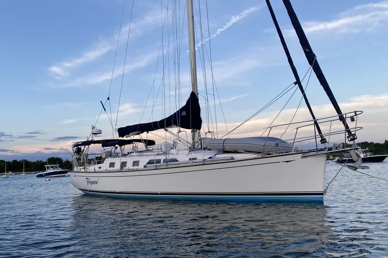 The Image of 2002 Saga 43 sailboat anchored on calm water at sunset. - 0