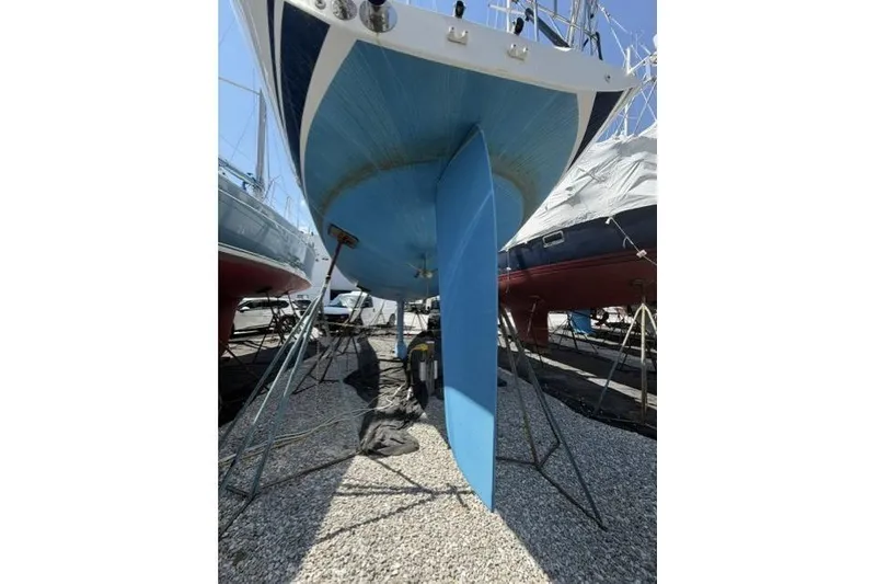 Slide: The Image of 2002 Saga 43 sailboat on dry dock, showing keel and hull. - 11