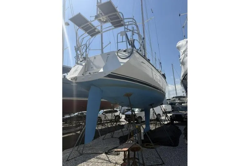 Slide: The Image of Sailboat Saga 43, 2002 model, on dry dock with solar panels, blue hull. - 12